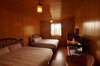 a bedroom with two beds and a desk and a window at 清境 百里莊園 Baili Manor Cing Jing in Ren&#39;ai