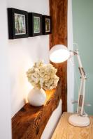 a lamp and a vase with a flower on a table at Gut Boltenhof in Fürstenberg