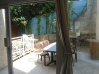 a view of a patio with a table and chairs at appartement saisonnier in Sorède