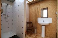 a bathroom with a sink and a shower and a mirror at camping chez l&#39;habitant in Noyal-Muzillac