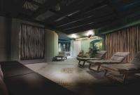 a living room with chairs and a couch and a table at the rex in Zermatt