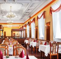 a dining room with tables and chairs and a chandelier at Reitenberger Spa Medical in Mariánské Lázně