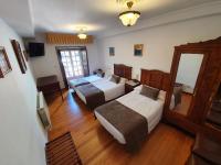 A bed or beds in a room at Hostal Giadás