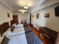 A bed or beds in a room at Hostal Giadás