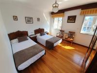 A bed or beds in a room at Hostal Giadás