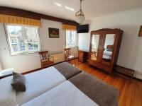 A bed or beds in a room at Hostal Giadás