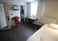 Un pat sau paturi &icirc;ntr-o camer&#x103; la Hotel Cortina