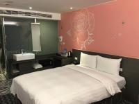 a hotel room with a bed and a sink at Chiayi Look Hotel in Chiayi City