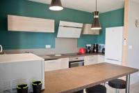 a kitchen with white cabinets and a counter top at Gîte Les Bourdettes in Auvillar