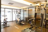 a gym with treadmills and ellipticals in a room at Just Sleep Kaohsiung Zhongzheng in Kaohsiung