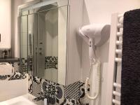 a shower in a bathroom with a sink and a phone at Parking Privé - Vue mer - WiFi - Centre Historique in Grasse