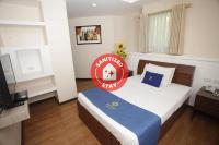 a bedroom with a bed with a sign on it at Star Hotel in Davao City