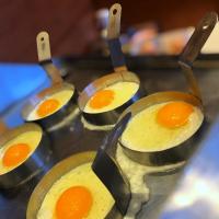 a group of eggs in metal cups on a stove at Hotel Vitality in Vendryně