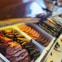 a display case with different types of meats and sausages at Hotel Vitality in Vendryně