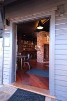 Una puerta a un patio con una mesa y una chimenea. en Jaspers Cabins, en Pemberton