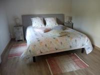 a bedroom with a bed with two night stands and two lamps at la providence in Boudeville