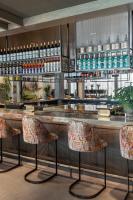 a bar with two chairs and a counter at Vignette Collection Yours Truly DC by IHG in Washington