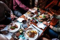 a group of people sitting around a table with food at The Address Connolly in Dublin