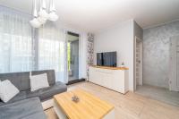 Televízia a/alebo spoločenská miestnosť v ubytovaní APARTAMENT PORTOVA Gdynia