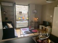 a living room with a table and two wine glasses at T2 centre ville avec extérieur in Avignon
