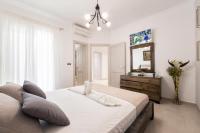 A bed or beds in a room at Panos Villa Sunset View