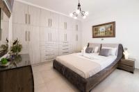 A bed or beds in a room at Panos Villa Sunset View