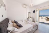 A bed or beds in a room at Panos Villa Sunset View