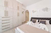 A bed or beds in a room at Panos Villa Sunset View