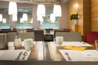 a wooden table with utensils on top of it at Holiday Inn Vienna City by IHG in Vienna