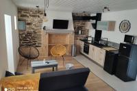 a kitchen and living room with a black refrigerator at brelevenez 18 rue crec h quellien in Lannion