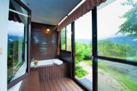 a room with a balcony with large glass windows at Margaret Garden Villa in Ren&#39;ai