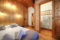 a bedroom with a bed in a wooden room at Chalet-Hôtel de l&#39;Etape in Les Contamines-Montjoie