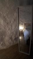 a bedroom with a bed and a mirror in a room at Casa Cueva “La Estrella” in Granada