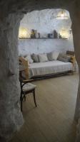 a bedroom with a bed in a stone wall at Casa Cueva “La Estrella” in Granada