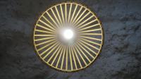 a circular light fixture hanging from a wall at Casa Cueva “La Estrella” in Granada