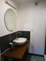 a bathroom with a sink and a mirror on a counter at Maison familiale, 15couchages, de charme au cœur de la Bretagne - 20 min de Vannes in Lizio