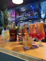 a group of drinks sitting on top of a bar at Le Plan B - Hôtel 3 étoiles - Restaurant in Ruoms