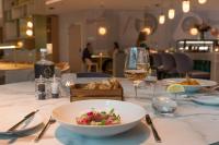 a table with a bowl of food and a glass of wine at Crowne Plaza Utrecht - Central Station by IHG in Utrecht