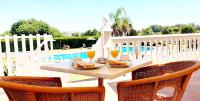a table with two glasses of orange juice and food at Hotel Diufain in Conil de la Frontera