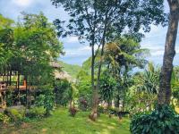 a view of a garden with trees and a house at Banyan Bay Villas in Ko Jum