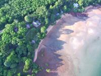 an overhead view of a beach with trees and water at Banyan Bay Villas in Ko Jum