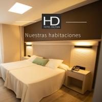 a hotel room with a bed and a nyssas haciendas sign at Hotel Diufain in Conil de la Frontera