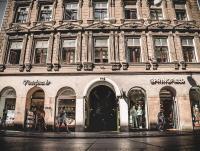 a building on a street with people walking in front of it at Timeout Heritage Hotel Zagreb in Zagreb