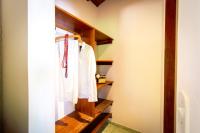a bathroom with a white shirt hanging on a rack at Pousada Por do Sol in Trancoso