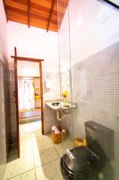 a bathroom with a glass shower and a sink at Pousada Por do Sol in Trancoso