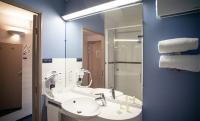 a bathroom with a sink and a mirror at Ace Hôtel Salon de Provence in Salon-de-Provence