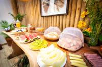 a wooden table with plates of food on it at Pousada Por do Sol in Trancoso