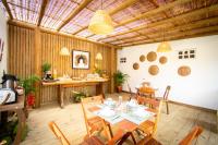 a dining room with a table and chairs at Pousada Por do Sol in Trancoso