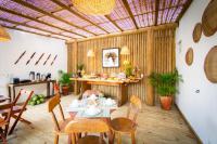 a dining room with a table and chairs at Pousada Por do Sol in Trancoso