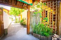 a fence in front of a building with plants at Pousada Por do Sol in Trancoso